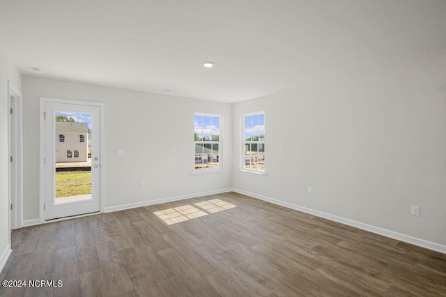 unfurnished room with hardwood / wood-style floors and a healthy amount of sunlight