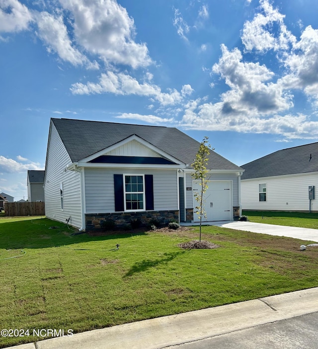 view of front of house with a garage and a front lawn