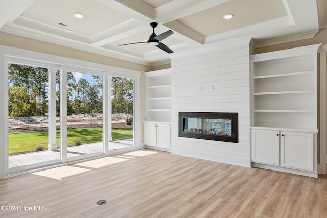 unfurnished living room featuring ceiling fan, beam ceiling, a multi sided fireplace, coffered ceiling, and light wood-type flooring