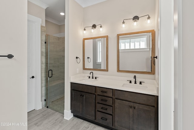 bathroom featuring vanity, an enclosed shower, hardwood / wood-style flooring, and crown molding