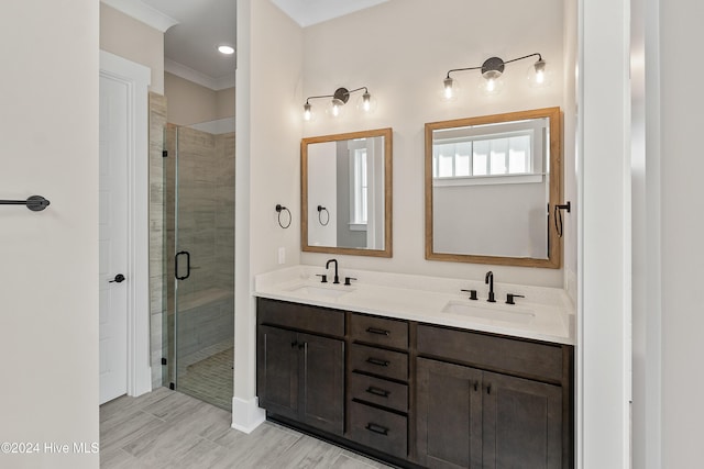 1105 Trisail Ter, Wilmington, NC 28412 - full bathroom featuring a shower stall, double vanity, wood finished floors, and crown molding