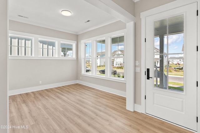 1105 Trisail Ter, Wilmington, NC 28412 - foyer entrance with plenty of natural light, wood finished floors, baseboards, and ornamental molding