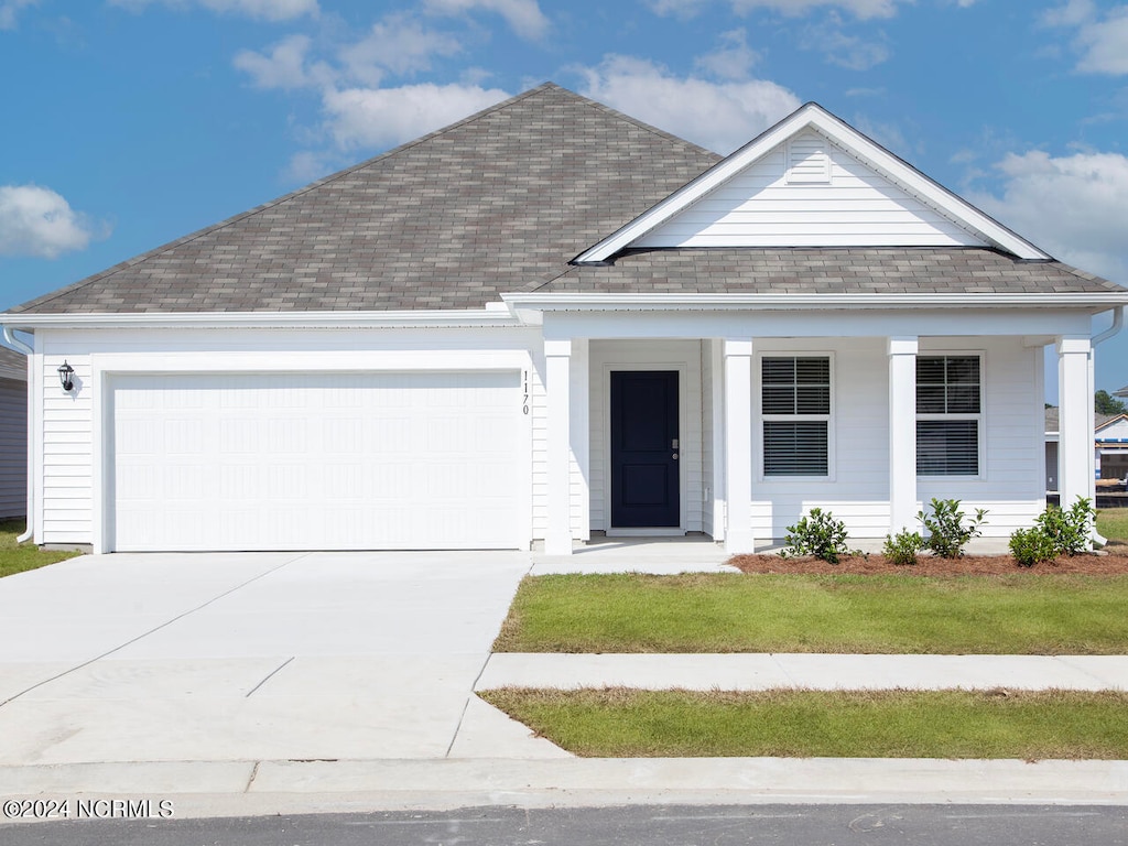 view of front of home featuring a porch and a garage