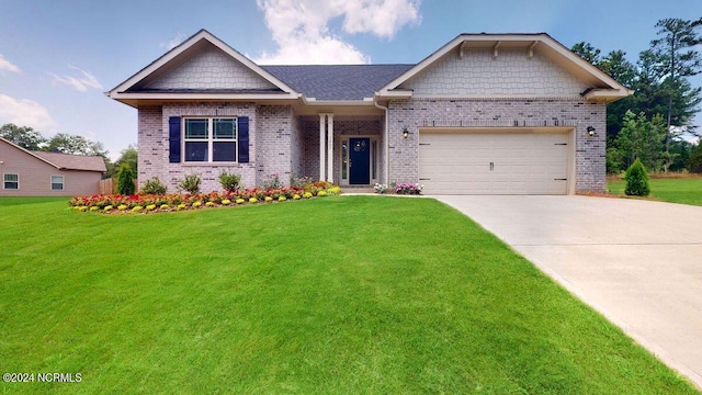 view of front of home featuring a front yard, brick siding, driveway, and an attached garage