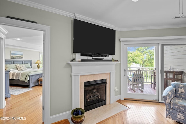 living room with a fireplace, hardwood / wood-style flooring, and ornamental molding