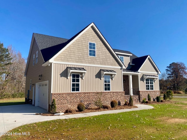 view of front of house with a front yard and a garage