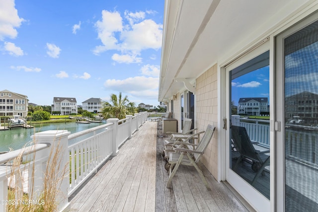 wooden deck featuring a water view