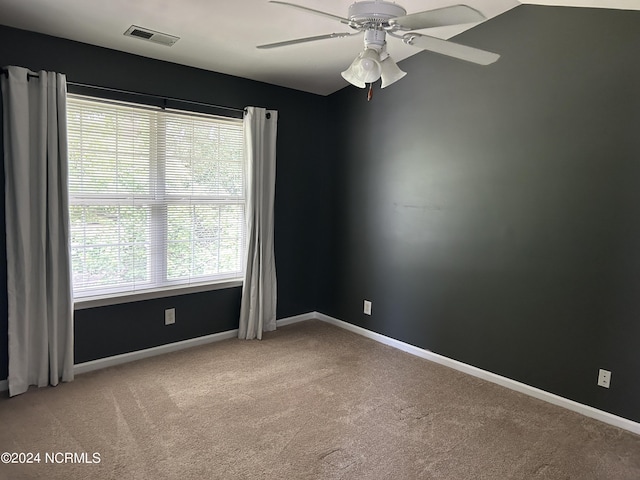 unfurnished room with light carpet, ceiling fan, visible vents, and baseboards