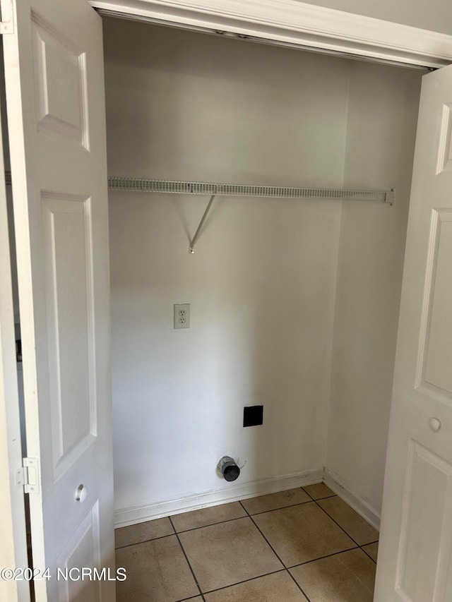 laundry area featuring tile flooring and electric dryer hookup