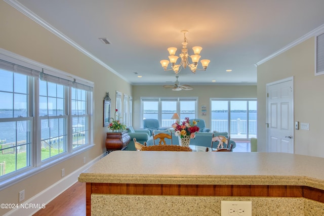 kitchen featuring plenty of natural light, a water view, and crown molding