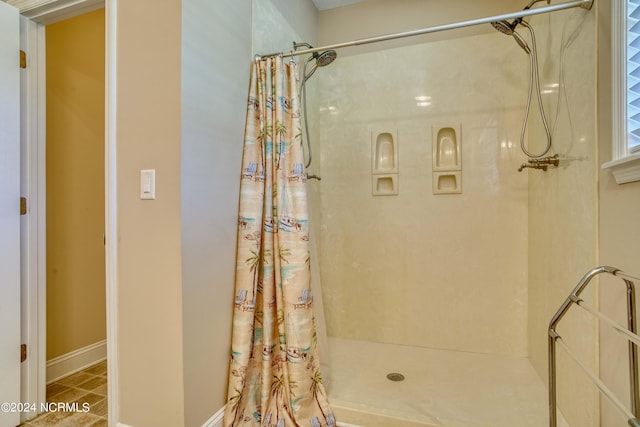 bathroom featuring tile patterned floors and curtained shower