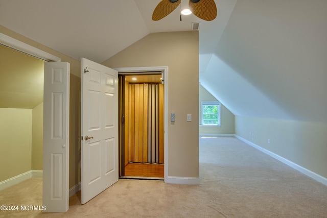 additional living space featuring ceiling fan, light carpet, and lofted ceiling