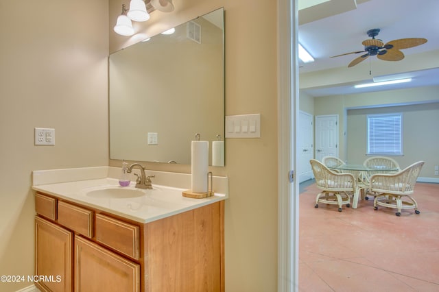 bathroom with tile patterned flooring, ceiling fan, and vanity