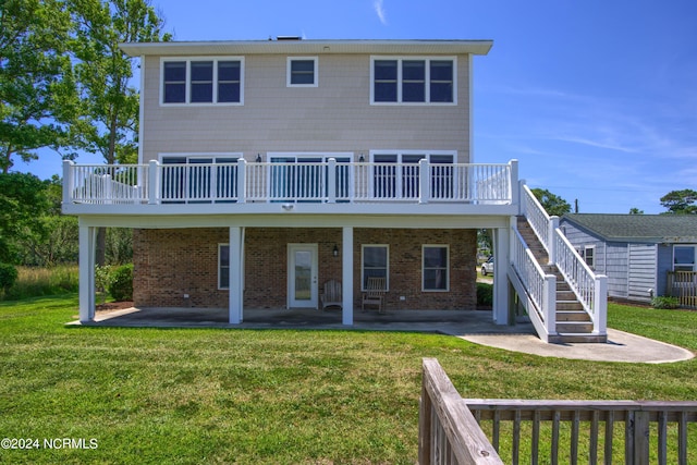 rear view of house with a lawn, a patio, and a deck