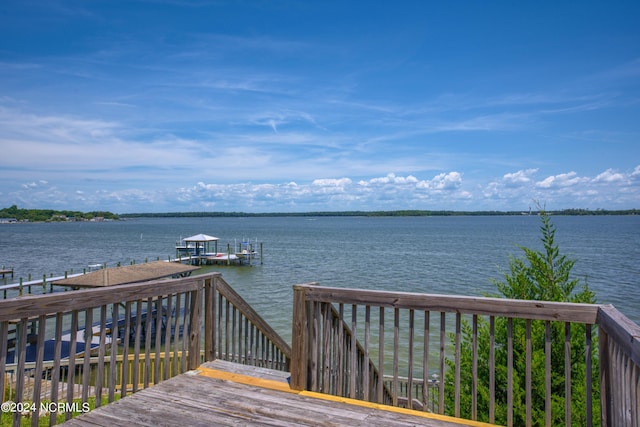 dock area featuring a deck with water view