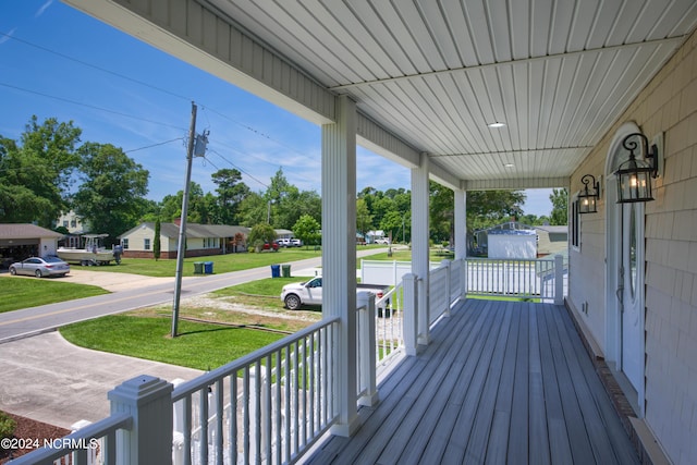 wooden deck with a yard and a porch