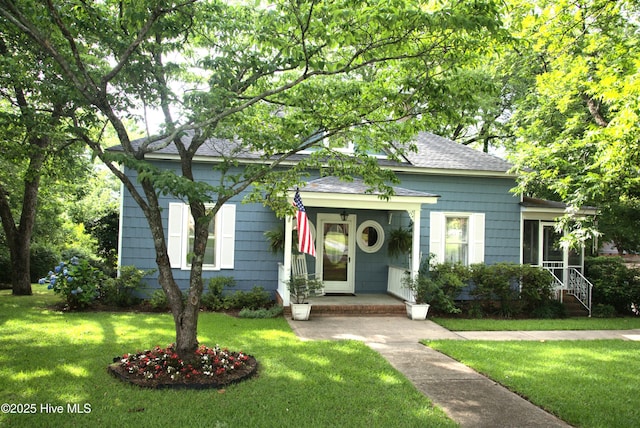 104 Rockingham St, Carthage, NC 28327 - view of front of property with a shingled roof and a front yard