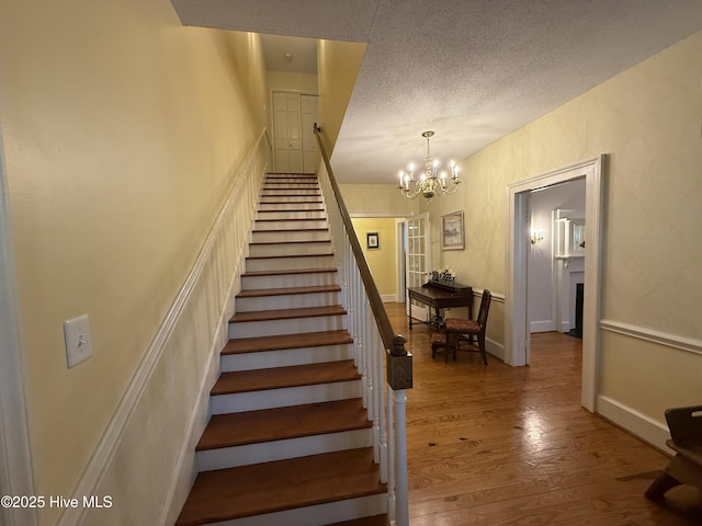 104 Rockingham St, Carthage, NC 28327 - stairs featuring a chandelier, wood finished floors, and a textured ceiling
