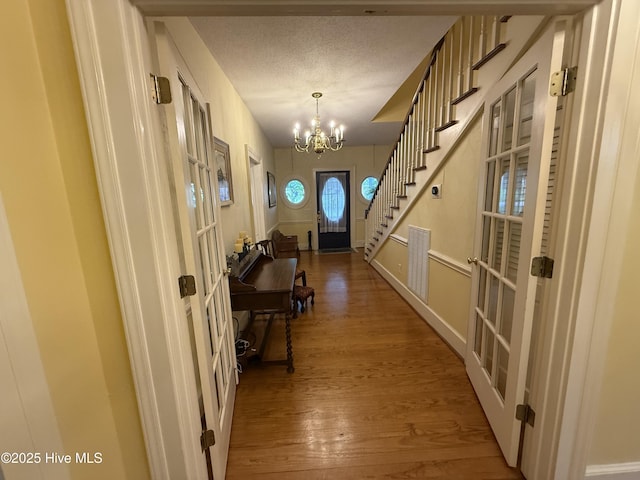 104 Rockingham St, Carthage, NC 28327 - entryway with french doors, wood finished floors, a chandelier, and stairs