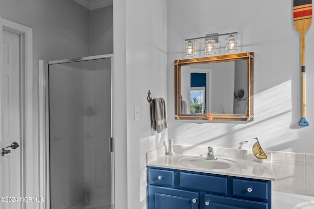 bathroom with vanity and a shower with door