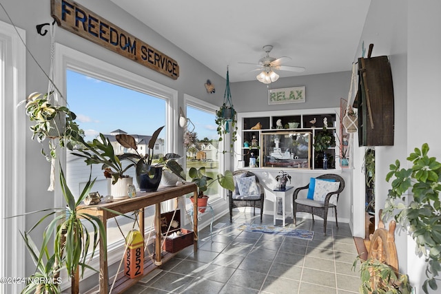 sunroom featuring ceiling fan