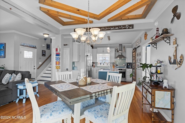 dining area featuring dark hardwood / wood-style flooring, ornamental molding, and a chandelier