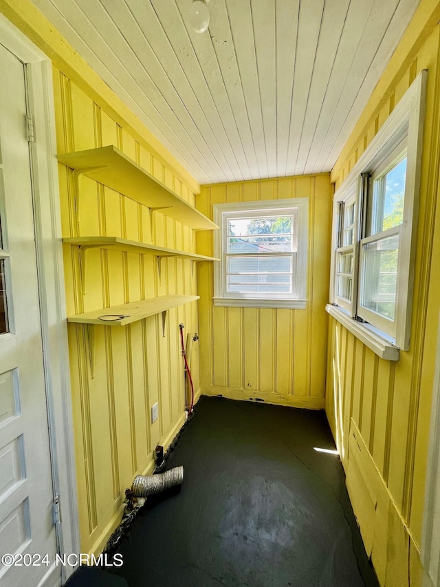 unfurnished sunroom featuring wooden ceiling and a healthy amount of sunlight