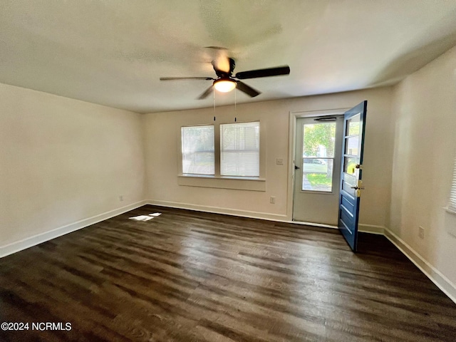 interior space with ceiling fan, baseboards, and dark wood-style flooring