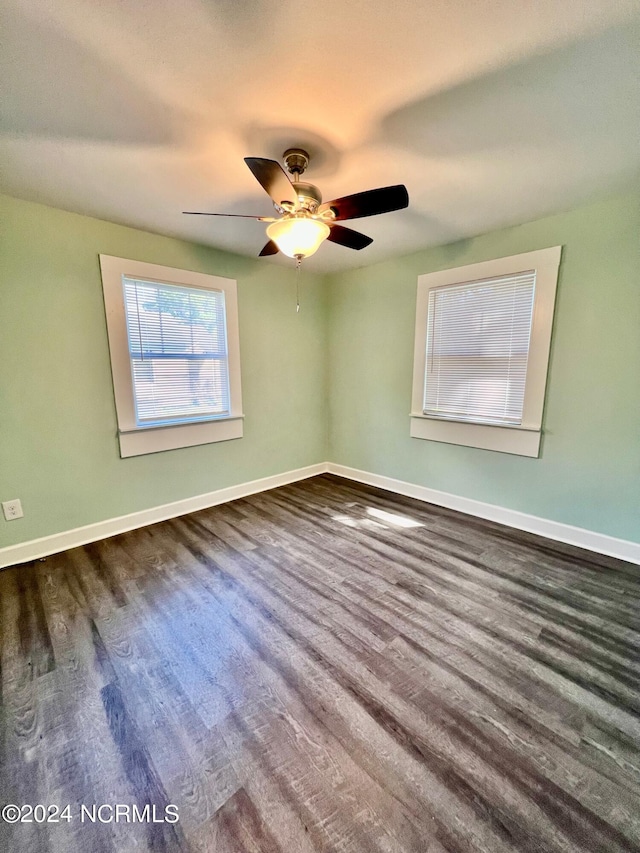 unfurnished room featuring a ceiling fan, baseboards, and wood finished floors