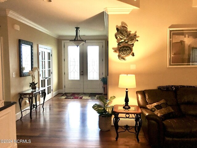 foyer entrance with dark hardwood / wood-style floors, french doors, and ornamental molding