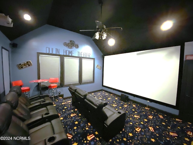 cinema featuring ceiling fan and high vaulted ceiling