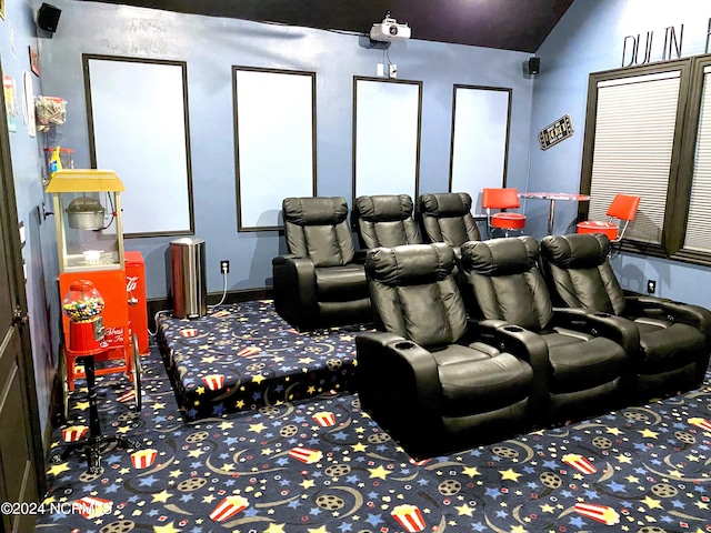 carpeted home theater featuring lofted ceiling