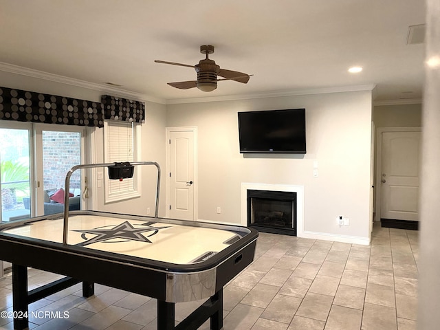 game room with ceiling fan, ornamental molding, and light tile patterned floors