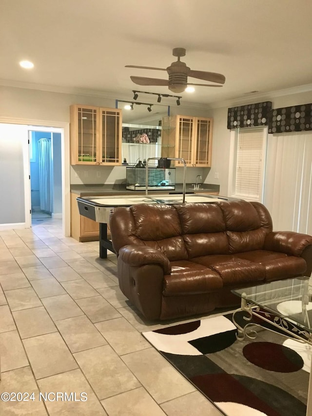 tiled living room featuring ceiling fan and ornamental molding