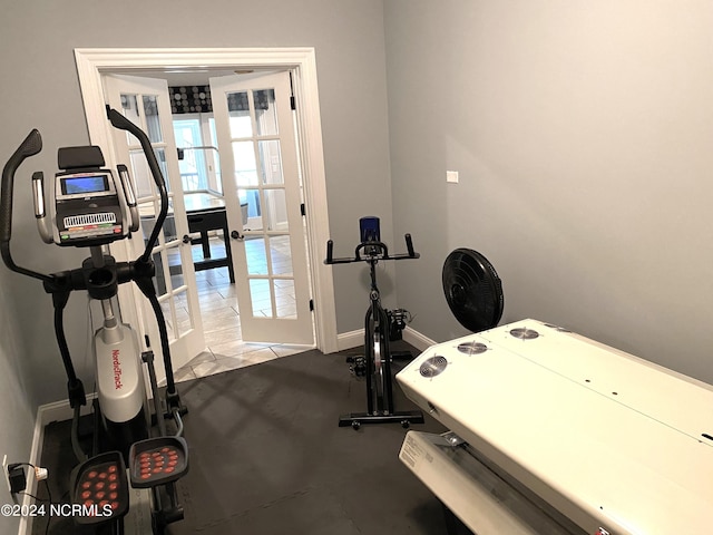 exercise area featuring french doors and light tile patterned floors