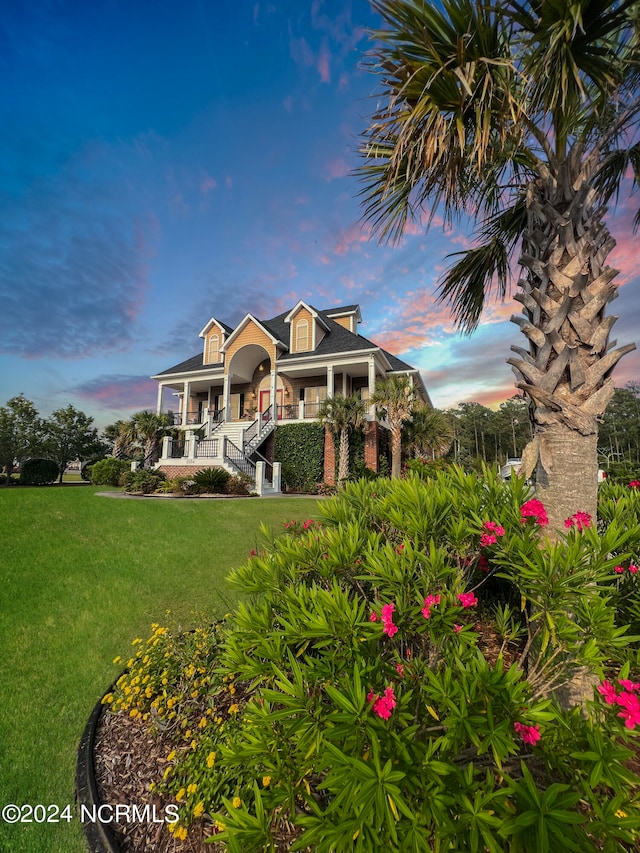 view of front of home featuring a porch and a front yard