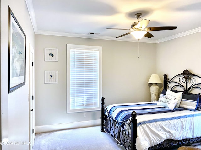 carpeted bedroom featuring ornamental molding and ceiling fan