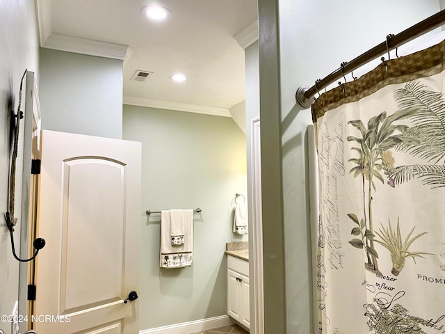 bathroom with ornamental molding and vanity