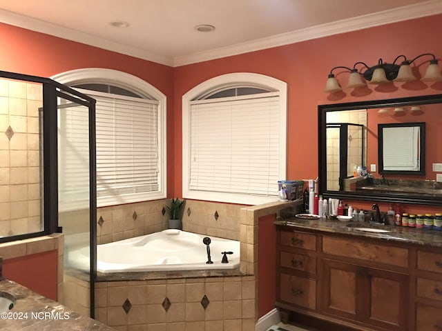 bathroom featuring vanity, crown molding, and tiled tub