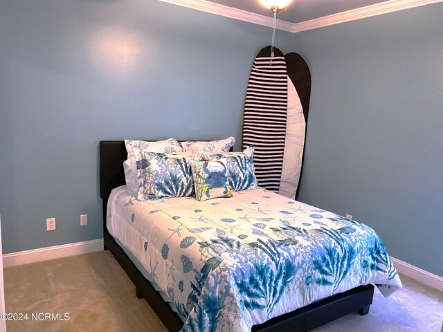 carpeted bedroom with ornamental molding