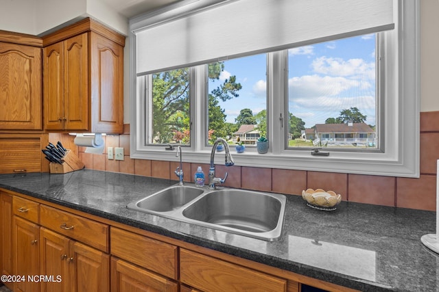 kitchen with sink and dark stone countertops