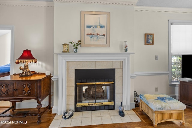 details featuring a tiled fireplace and hardwood / wood-style floors