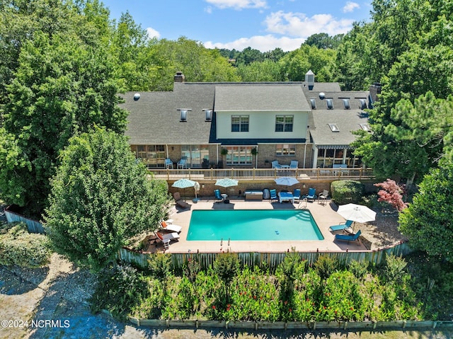 back of house featuring a patio area and a fenced in pool