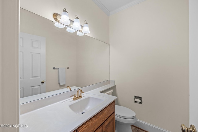 bathroom featuring ornamental molding, toilet, and vanity