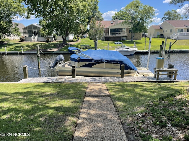 view of dock with a water view and a yard