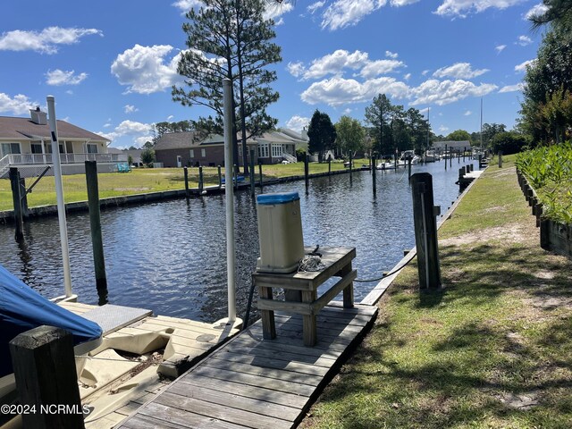 dock area featuring a water view and a yard