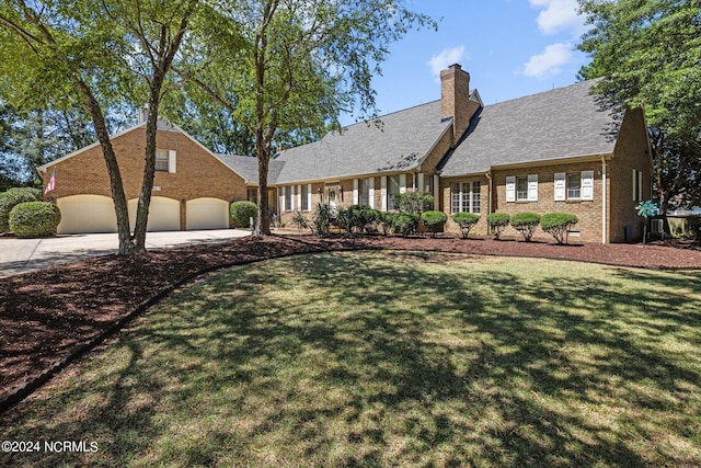 new england style home featuring a garage and a front yard