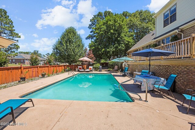 view of swimming pool with a patio