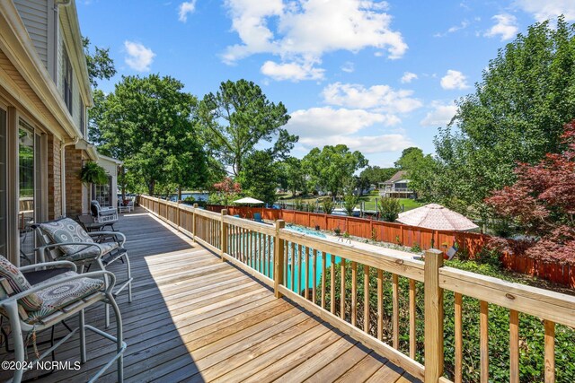 wooden terrace featuring a pool