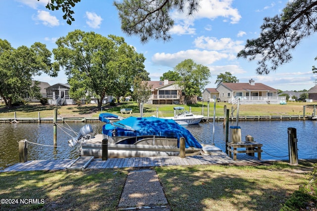 dock area with a yard and a water view